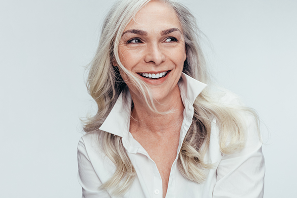 Woman with blonde hair smiling at camera.